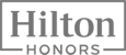 The image features the logo for Hilton Honors, the rewards program by Hilton Hotels. The text reads "Hilton Honors."